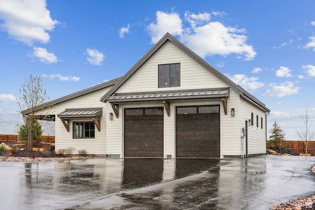 205 W Lazy Acres Ln, Kamas, UT 84036 - view of front facade featuring a garage, fence, a standing seam roof, and metal roof