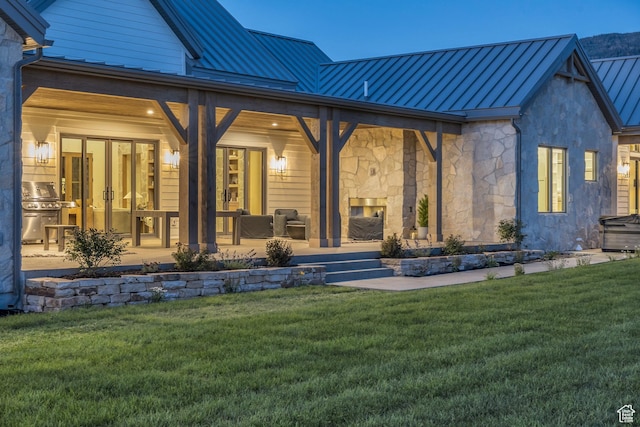 205 W Lazy Acres Ln, Kamas, UT 84036 - rear view of property with french doors, a standing seam roof, a multi sided fireplace, metal roof, and a yard