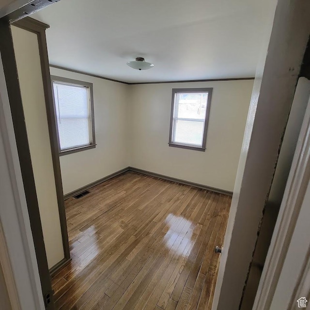 207 N Rawlins St, East Carbon, UT 84520 - unfurnished room with baseboards, visible vents, and hardwood / wood-style floors