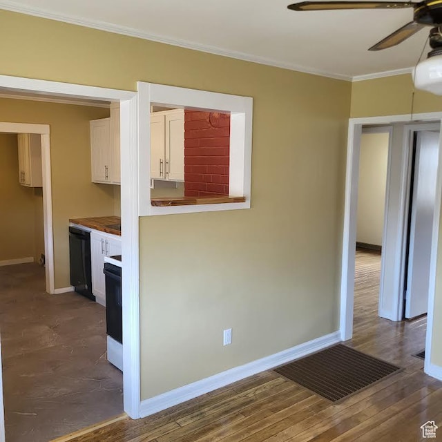 207 N Rawlins St, East Carbon, UT 84520 - kitchen with ornamental molding, baseboards, black dishwasher, white cabinetry, and a ceiling fan