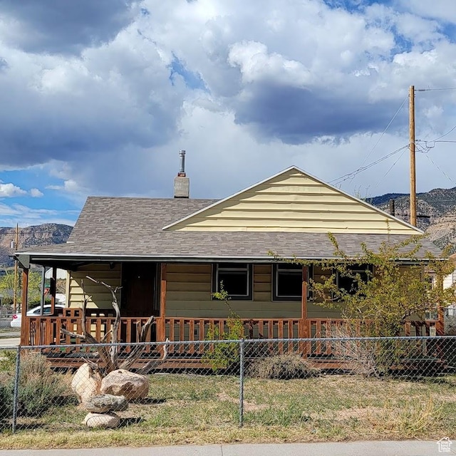 207 N Rawlins St, East Carbon, UT 84520 - country-style home featuring fence, a chimney, and a porch