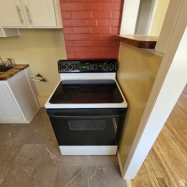 207 N Rawlins St, East Carbon, UT 84520 - room details with white cabinets and electric range