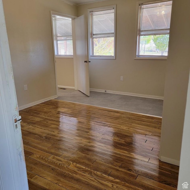 207 N Rawlins St, East Carbon, UT 84520 - unfurnished room featuring baseboards, wood finished floors, and a wealth of natural light