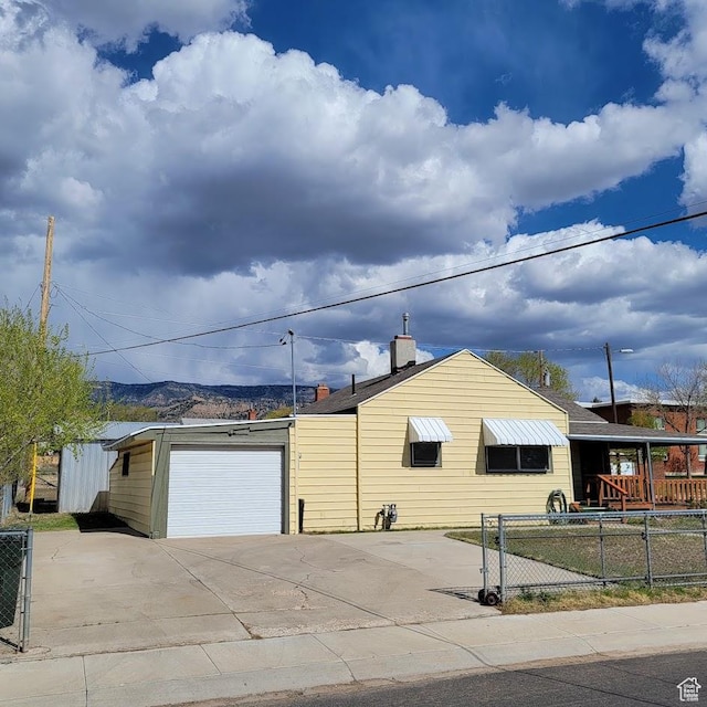 207 N Rawlins St, East Carbon, UT 84520 - exterior space featuring a garage, fence, and driveway