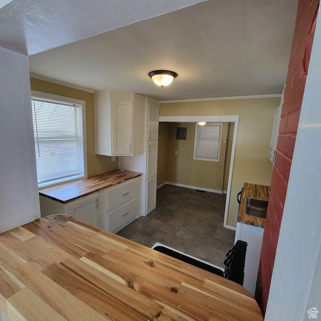 207 N Rawlins St, East Carbon, UT 84520 - kitchen with a sink, ornamental molding, wood counters, and white cabinets
