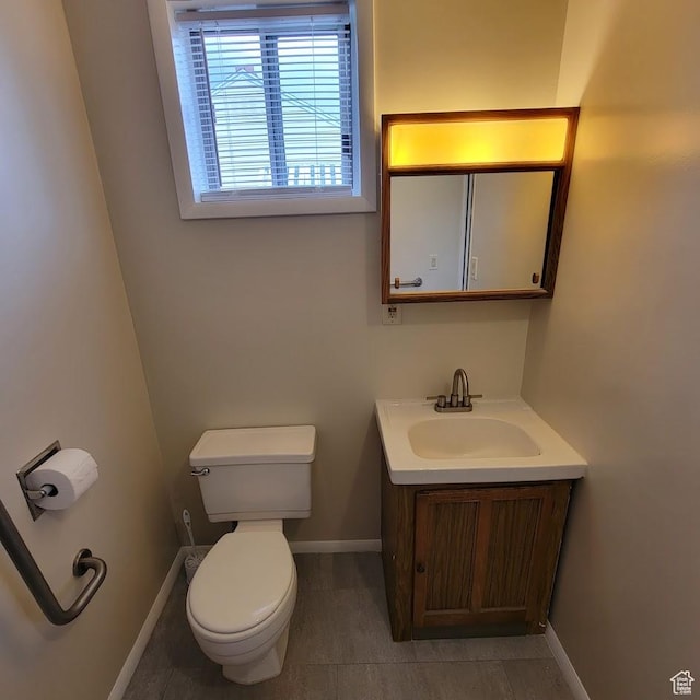 207 N Rawlins St, East Carbon, UT 84520 - bathroom featuring toilet, baseboards, and vanity