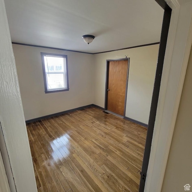 207 N Rawlins St, East Carbon, UT 84520 - spare room with wood-type flooring, ornamental molding, and baseboards