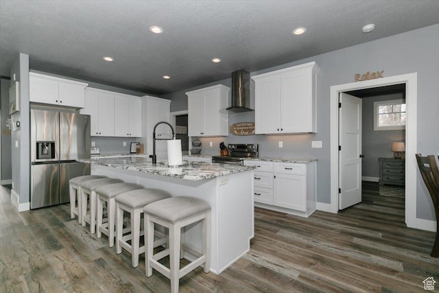207 E Clubhouse Dr Unit 40, Garden City, UT 84028 - kitchen featuring appliances with stainless steel finishes, wall chimney exhaust hood, dark wood finished floors, baseboards, and recessed lighting