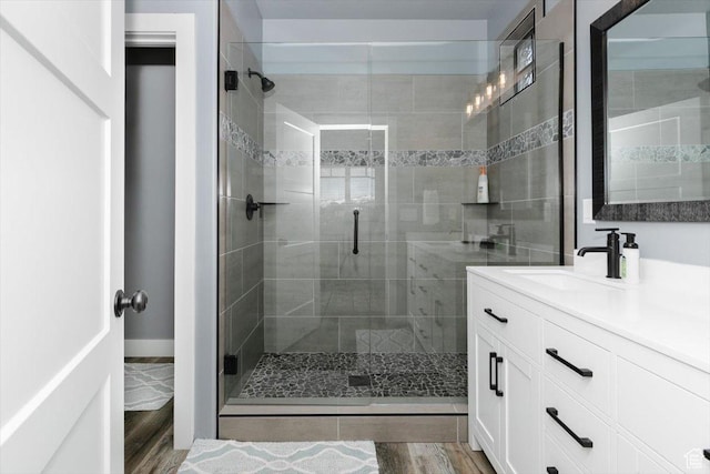 207 E Clubhouse Dr Unit 40, Garden City, UT 84028 - full bath featuring a stall shower, vanity, and wood finished floors