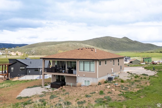 207 E Clubhouse Dr Unit 40, Garden City, UT 84028 - rear view of house featuring a mountain view, a patio area, and roof with shingles