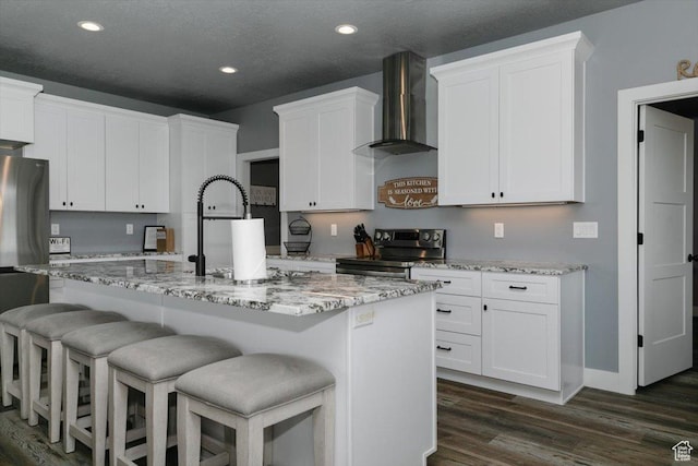 207 E Clubhouse Dr Unit 40, Garden City, UT 84028 - kitchen featuring stainless steel appliances, wall chimney range hood, recessed lighting, white cabinetry, and dark wood-style floors