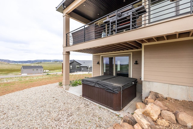 207 E Clubhouse Dr Unit 40, Garden City, UT 84028 - view of patio / terrace with a hot tub, a balcony, and a mountain view