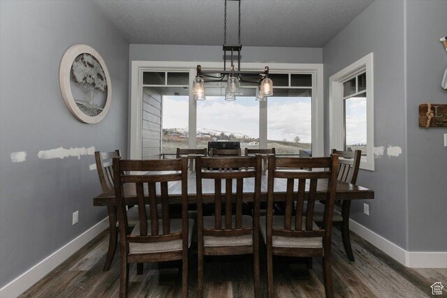 207 E Clubhouse Dr Unit 40, Garden City, UT 84028 - dining room featuring wood finished floors, baseboards, and a textured ceiling