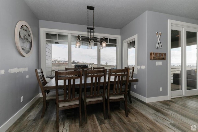 207 E Clubhouse Dr Unit 40, Garden City, UT 84028 - dining space with baseboards, dark wood-style floors, plenty of natural light, a textured ceiling, and a chandelier