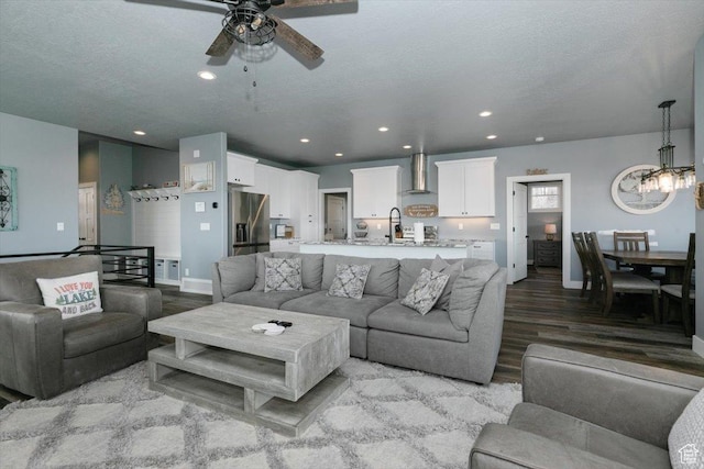 207 E Clubhouse Dr Unit 40, Garden City, UT 84028 - living area with a ceiling fan, wood finished floors, baseboards, a chandelier, and recessed lighting