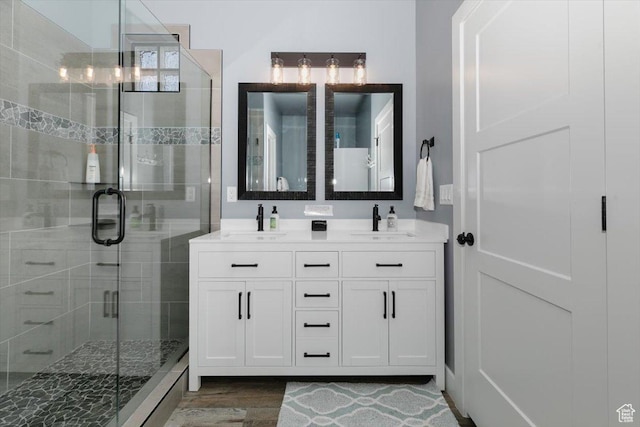 207 E Clubhouse Dr Unit 40, Garden City, UT 84028 - full bathroom featuring wood finished floors, a shower stall, and double vanity