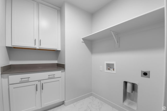 washroom featuring marble finish floor, baseboards, hookup for an electric dryer, cabinet space, and washer hookup