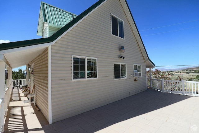 view of property exterior with a mountain view