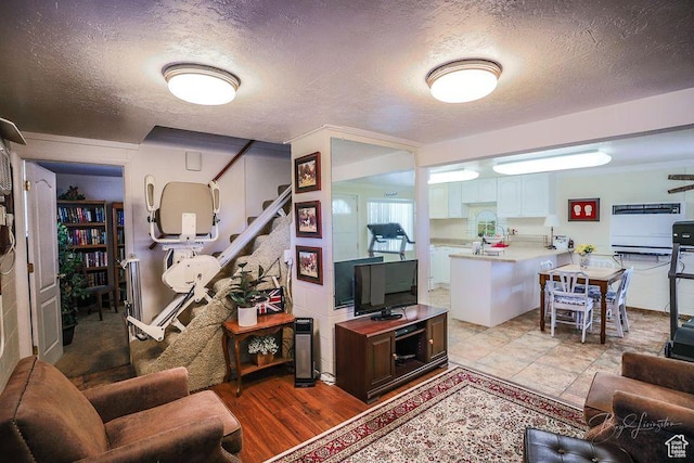 living area featuring a textured ceiling