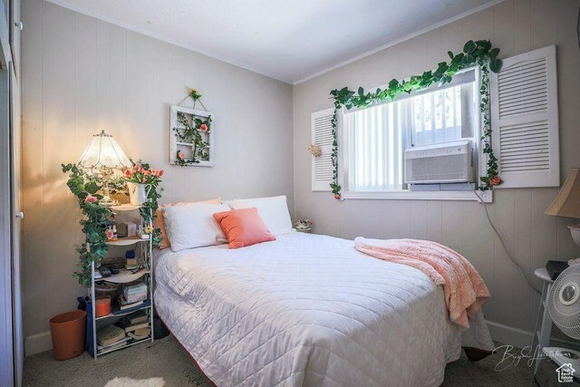 carpeted bedroom with crown molding, cooling unit, and wood walls