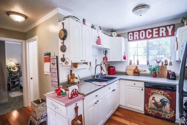 kitchen with crown molding, white cabinets, a sink, dark wood-type flooring, and dishwashing machine