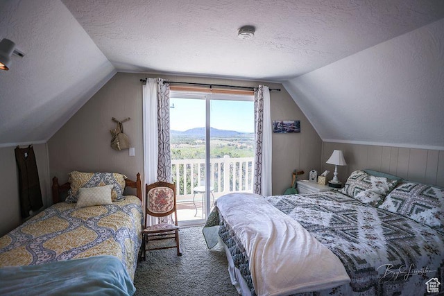 bedroom with access to outside, carpet flooring, a textured ceiling, and lofted ceiling