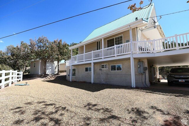 view of side of home with an outdoor structure and metal roof