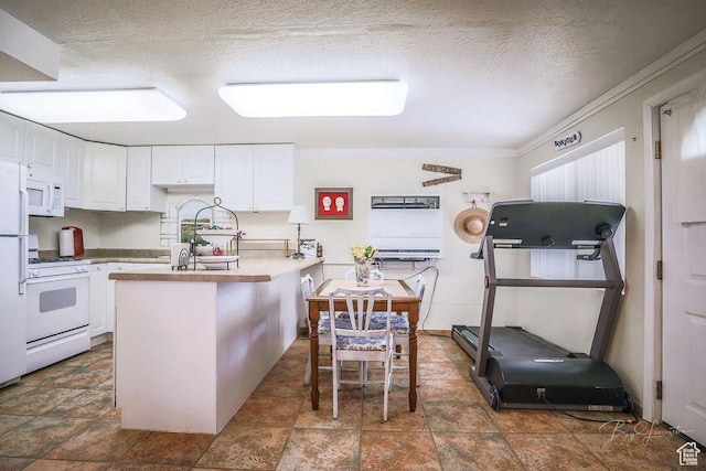 kitchen featuring white appliances, white cabinetry, a textured ceiling, and stone finish flooring