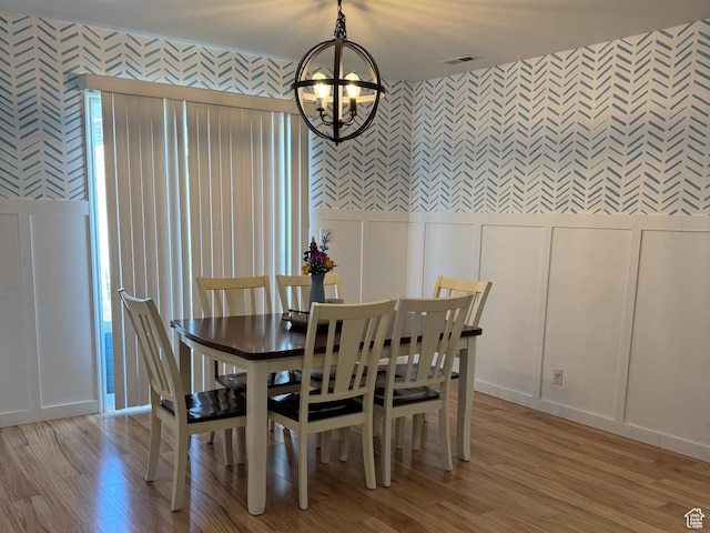 2689 S 800 W, Nibley, UT 84321 - dining area with a notable chandelier, light wood-style floors, a decorative wall, wallpapered walls, and visible vents