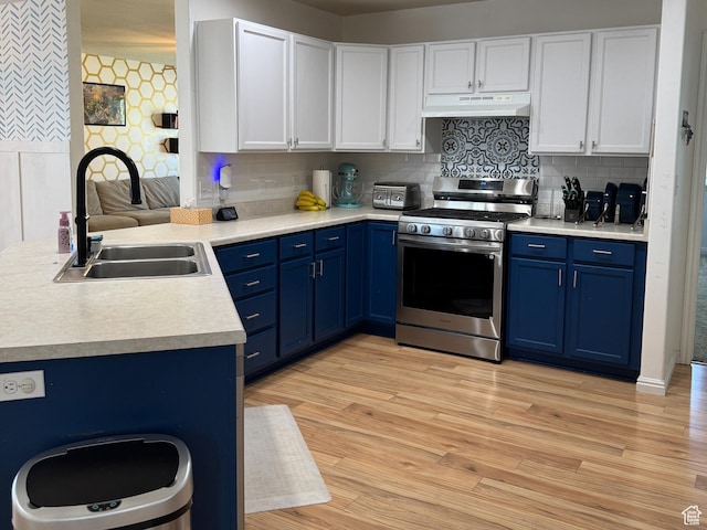 2689 S 800 W, Nibley, UT 84321 - kitchen featuring stainless steel gas stove, light countertops, under cabinet range hood, a sink, and blue cabinetry