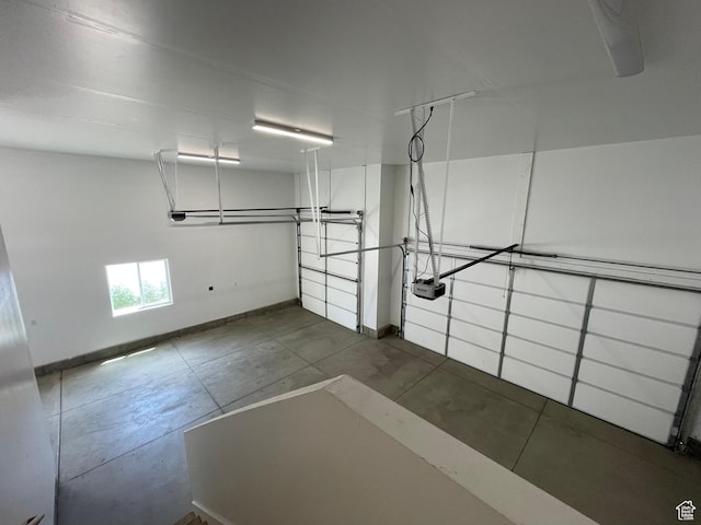 3834 N 2550 W, Farr West, UT 84404 - garage featuring baseboards and a garage door opener