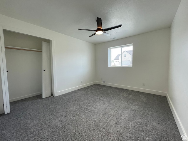 3834 N 2550 W, Farr West, UT 84404 - unfurnished bedroom with dark carpet, a ceiling fan, and a closet