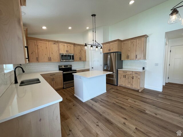 3834 N 2550 W, Farr West, UT 84404 - kitchen featuring appliances with stainless steel finishes, a center island, tasteful backsplash, dark wood finished floors, and recessed lighting