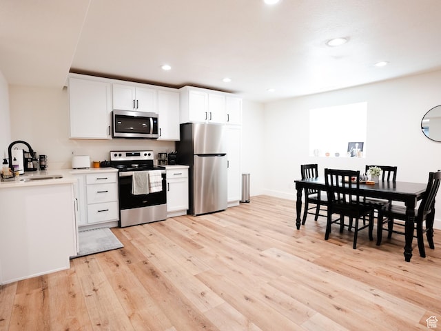 3834 N 2550 W, Farr West, UT 84404 - kitchen with a sink, light wood-style floors, stainless steel appliances, and recessed lighting