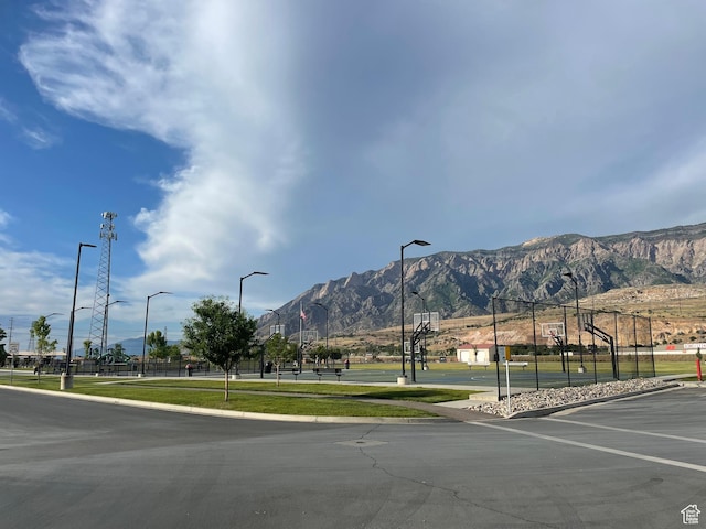 3834 N 2550 W, Farr West, UT 84404 - view of asphalt street with street lighting, a mountain view, and curbs
