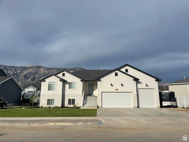 3834 N 2550 W, Farr West, UT 84404 - view of front facade featuring concrete driveway, a front lawn, stucco siding, a mountain view, and a garage