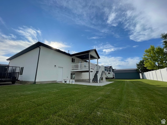 3834 N 2550 W, Farr West, UT 84404 - rear view of house with stairway, a wooden deck, a patio, and stucco siding