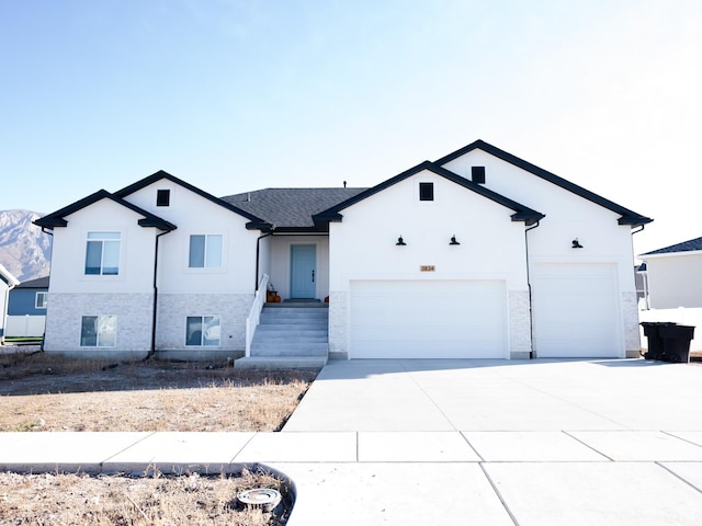 ranch-style home featuring an attached garage, driveway, and stucco siding