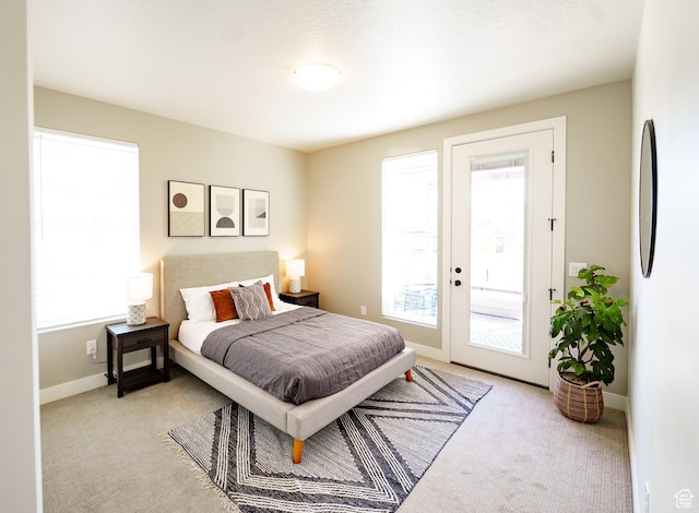 7093 W Granbury Dr S Unit 255, South Jordan, UT 84009 - carpeted bedroom with baseboards, access to outside, and multiple windows