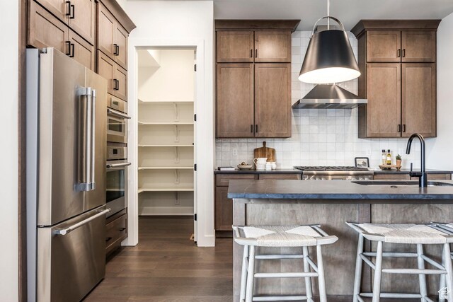 359 N Abajo Peak Loop E Unit A3, Heber City, UT 84032 - kitchen with decorative backsplash, dark wood-style flooring, dark countertops, a sink, and stainless steel appliances