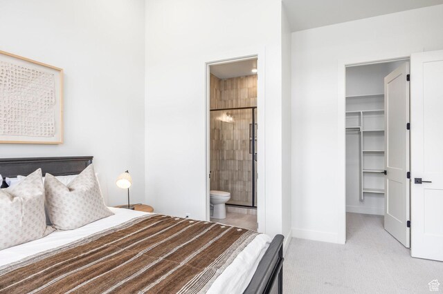359 N Abajo Peak Loop E Unit A3, Heber City, UT 84032 - bedroom featuring a walk in closet, baseboards, a closet, connected bathroom, and carpet