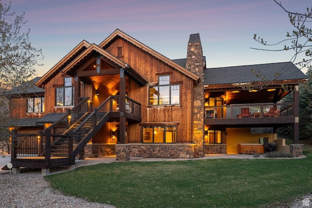 2042 Paddington Dr, Park City, UT 84060 - rear view of house featuring a lawn, stone siding, a chimney, and a balcony