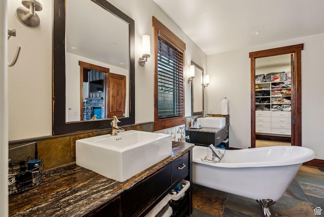 2042 Paddington Dr, Park City, UT 84060 - bathroom with a walk in closet, a freestanding tub, two vanities, and a sink