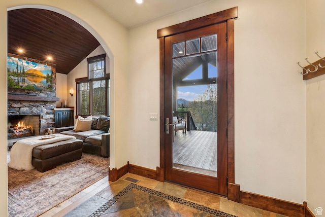 2042 Paddington Dr, Park City, UT 84060 - doorway with lofted ceiling, baseboards, a fireplace, and plenty of natural light