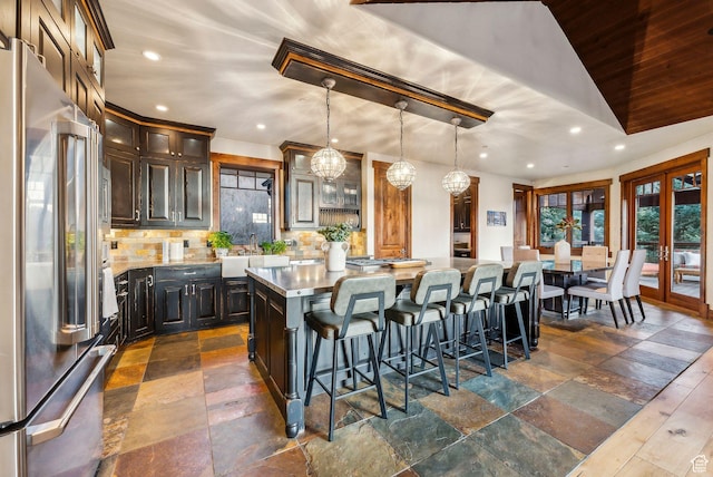 2042 Paddington Dr, Park City, UT 84060 - kitchen with stone tile flooring, a kitchen island, tasteful backsplash, and high end refrigerator