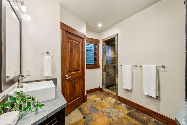 2042 Paddington Dr, Park City, UT 84060 - bathroom with baseboards, vanity, stone finish floor, and a stall shower
