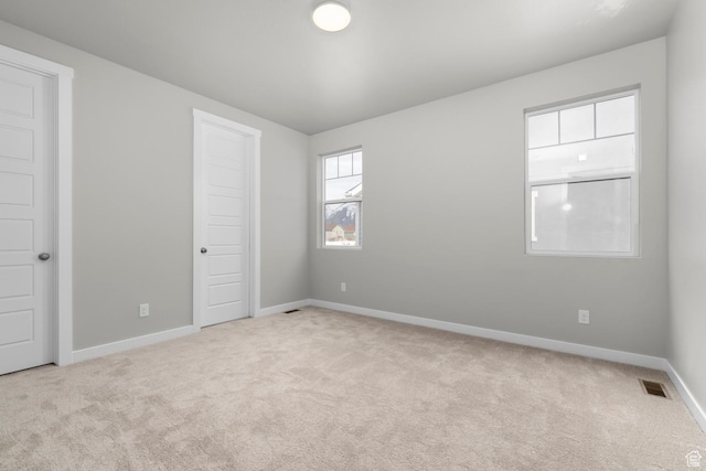 674 W Junegrass Ln, Stansbury Park, UT 84074 - unfurnished bedroom with baseboards, visible vents, and carpet