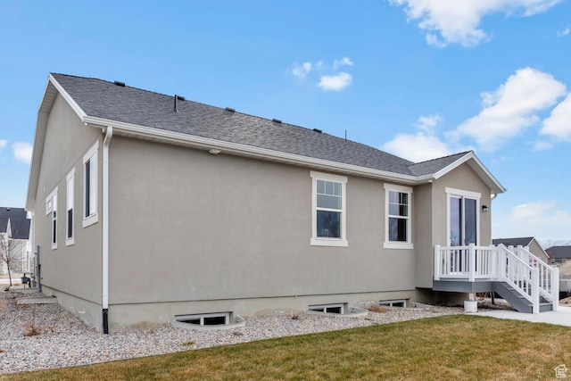 674 W Junegrass Ln, Stansbury Park, UT 84074 - rear view of house featuring a yard and stucco siding