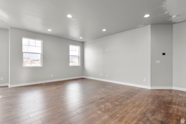 674 W Junegrass Ln, Stansbury Park, UT 84074 - empty room with baseboards, recessed lighting, and dark wood-type flooring