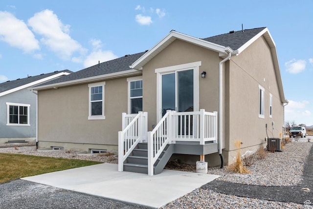 674 W Junegrass Ln, Stansbury Park, UT 84074 - back of property featuring a patio, central AC, and stucco siding